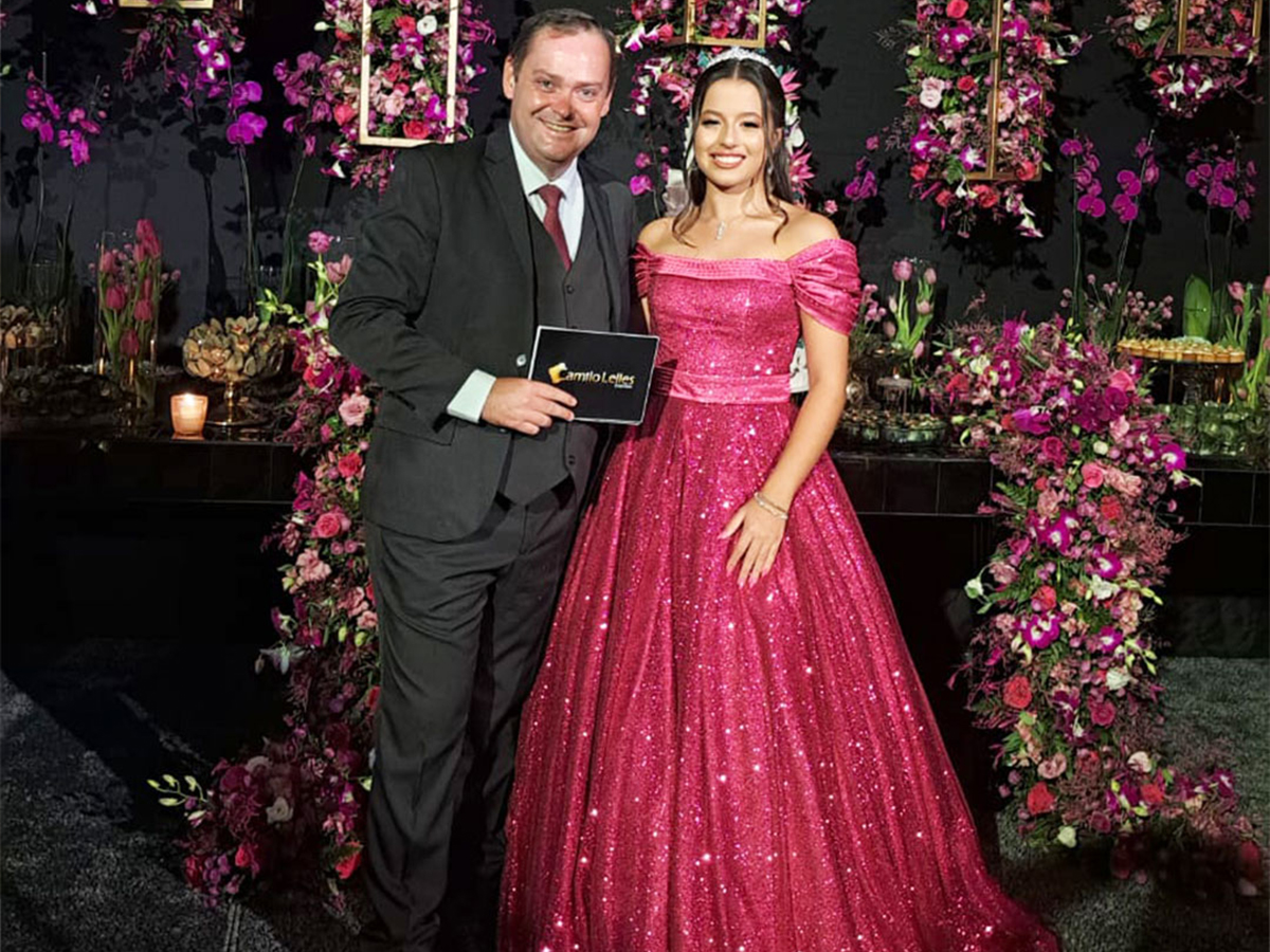 Camilo Lelles com debutante de vestido rosa em festa de 15 anos